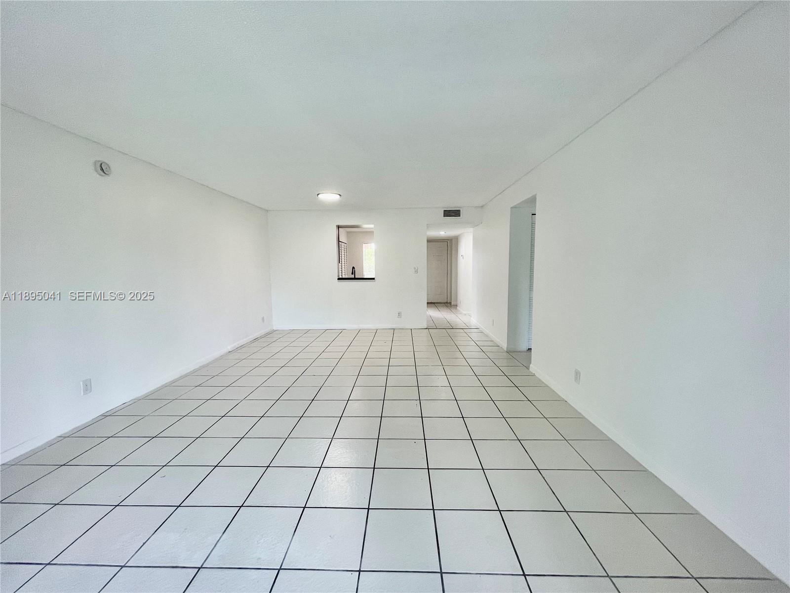 2209 South Cypress Bend Drive, Unit 407 Pompano Beach, FL 33069 - Photo 11 of 53 a view of an empty room and window