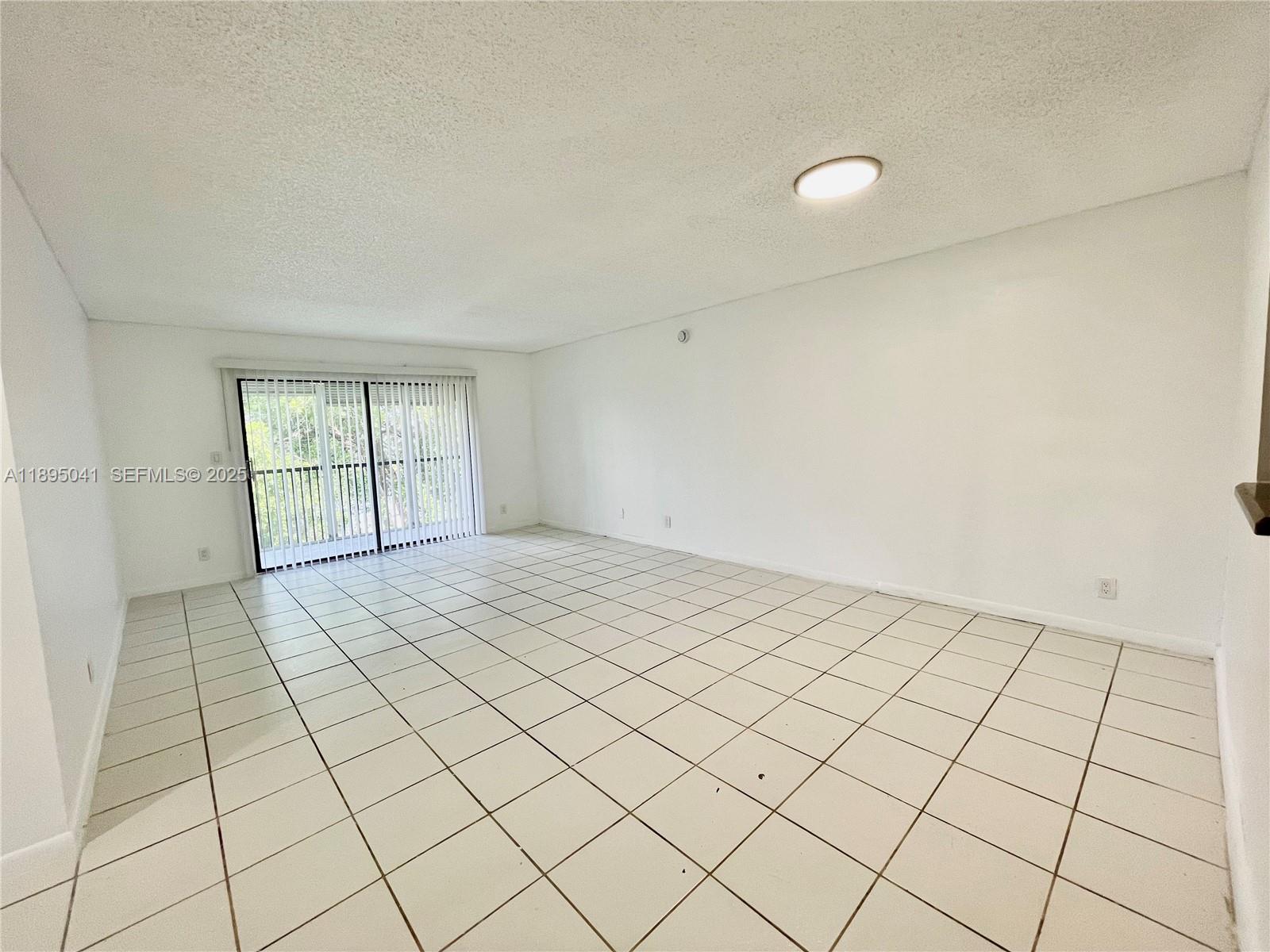 2209 South Cypress Bend Drive, Unit 407 Pompano Beach, FL 33069 - Photo 12 of 53 a view of an empty room and window