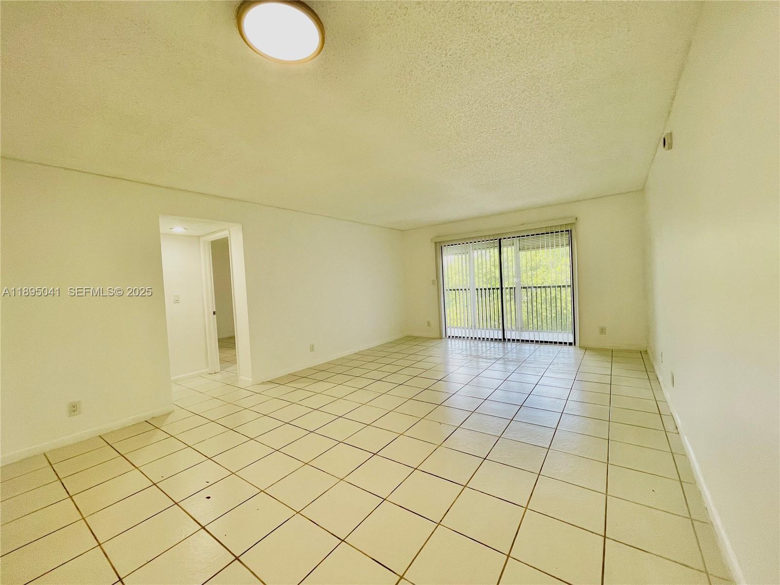 2209 South Cypress Bend Drive, Unit 407 Pompano Beach, FL 33069 - Photo 17 of 53 a view of an empty room and window