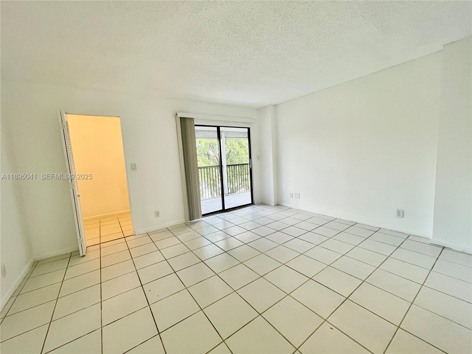 2209 South Cypress Bend Drive, Unit 407 Pompano Beach, FL 33069 - Photo 18 of 53 a view of an empty room and window