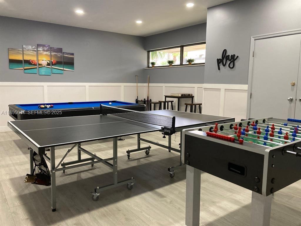 2209 South Cypress Bend Drive, Unit 407 Pompano Beach, FL 33069 - Photo 46 of 53 a room with gym equipment and wooden floor