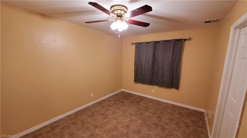 7319 Albany Road Fort Myers, FL 33967 - Photo 14 of 47 an empty room with windows and fan