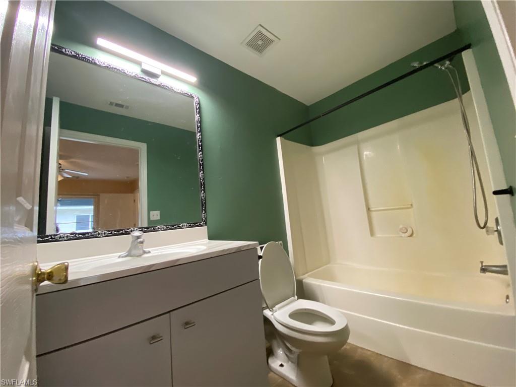 7319 Albany Road Fort Myers, FL 33967 - Photo 29 of 47 a bathroom with a sink a toilet and a mirror