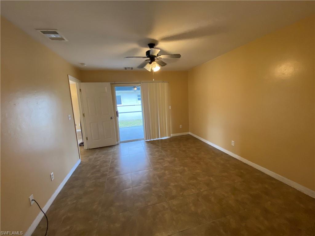 7319 Albany Road Fort Myers, FL 33967 - Photo 30 of 47 an empty room with a window and a ceiling fan