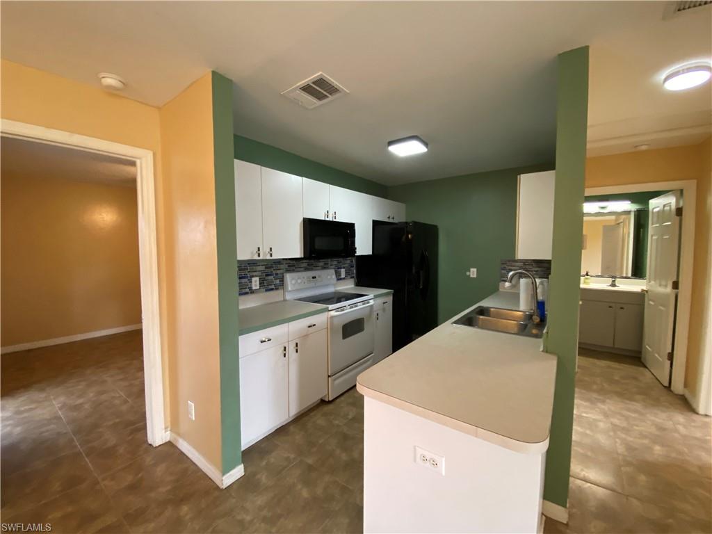7319 Albany Road Fort Myers, FL 33967 - Photo 33 of 47 a kitchen that has a lot of cabinets and wooden floor