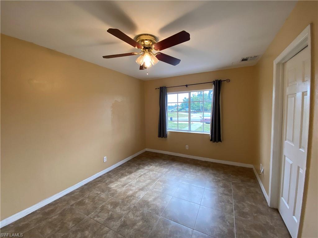 7319 Albany Road Fort Myers, FL 33967 - Photo 34 of 47 an empty room with windows and fan