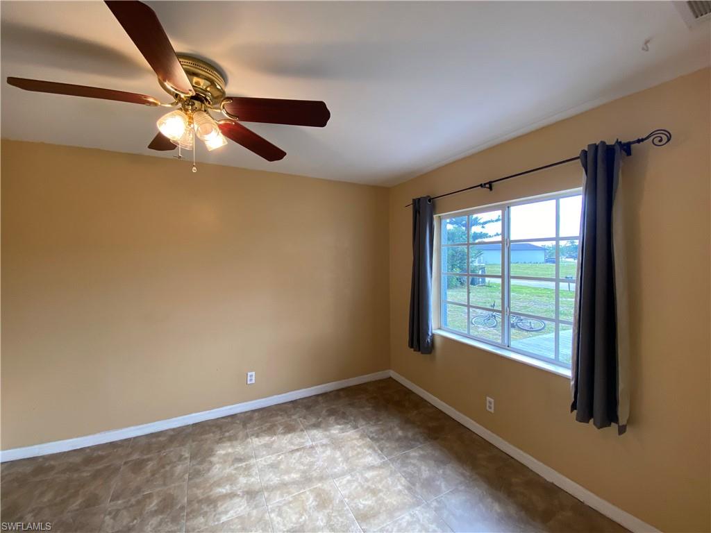 7319 Albany Road Fort Myers, FL 33967 - Photo 36 of 47 an empty room with a window and a fan