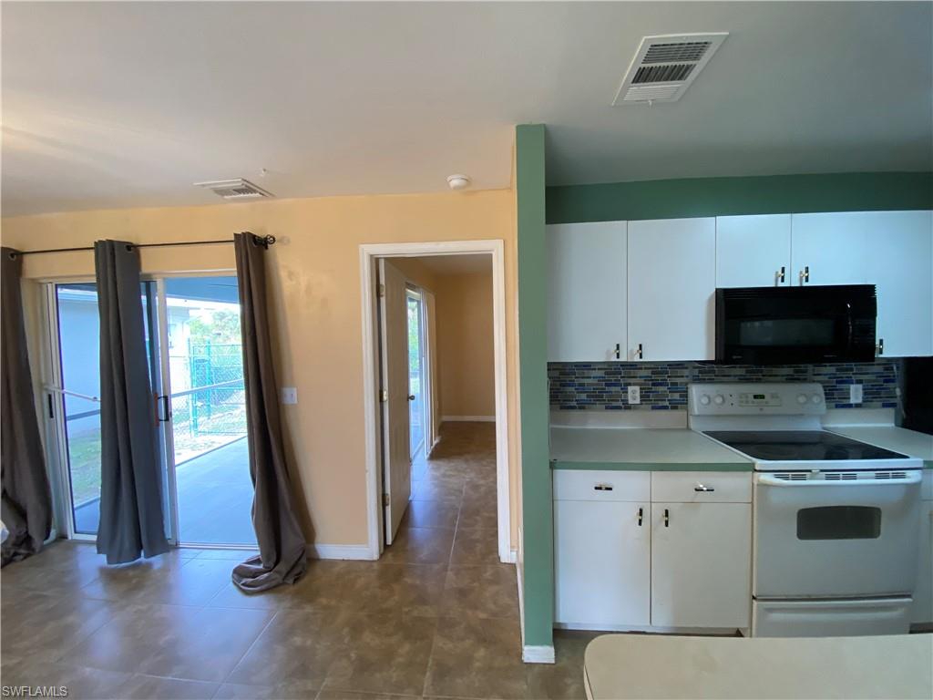 7319 Albany Road Fort Myers, FL 33967 - Photo 7 of 47 a view of a kitchen with a sink wooden floor and a fireplace
