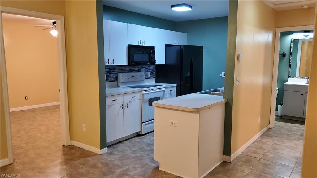 7319 Albany Road Fort Myers, FL 33967 - Photo 9 of 47 a kitchen that has a sink and a stove in it