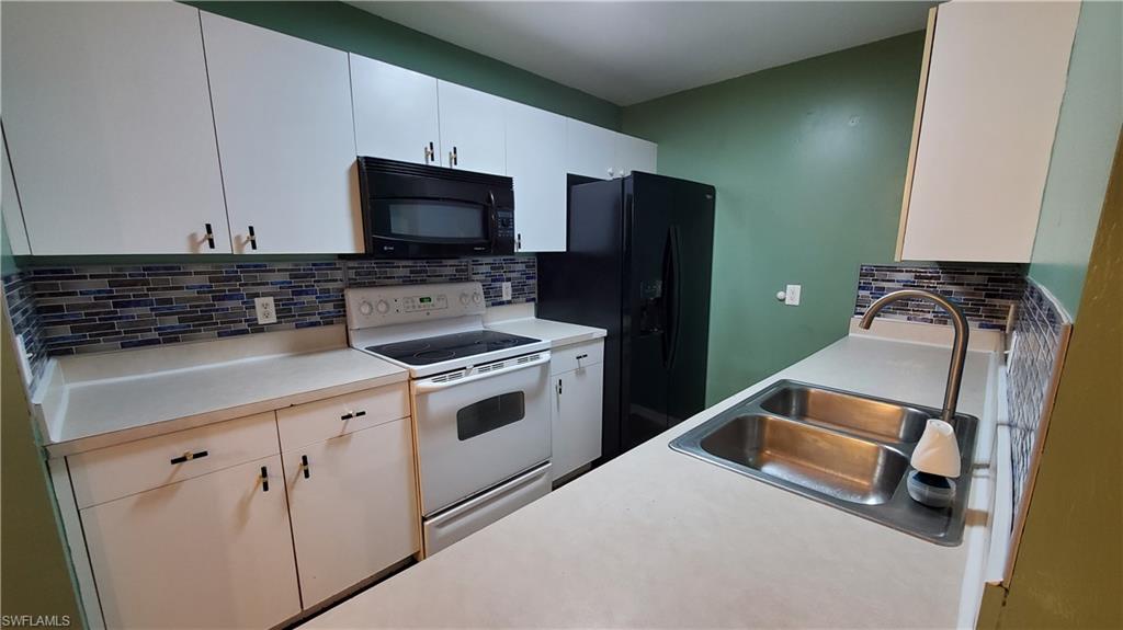 7319 Albany Road Fort Myers, FL 33967 - Photo 10 of 47 a kitchen with a stove and a microwave