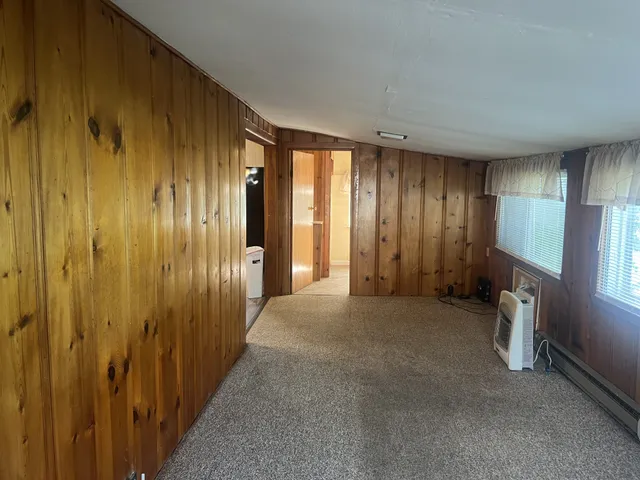 a view of a livingroom with an empty space and a window