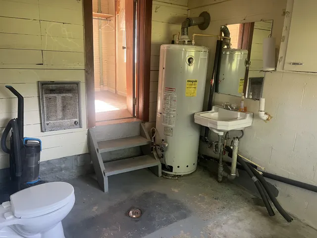 a bathroom with a sink a toilet and a mirror