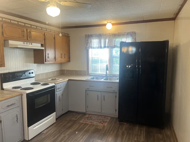 a kitchen with a sink stove and refrigerator