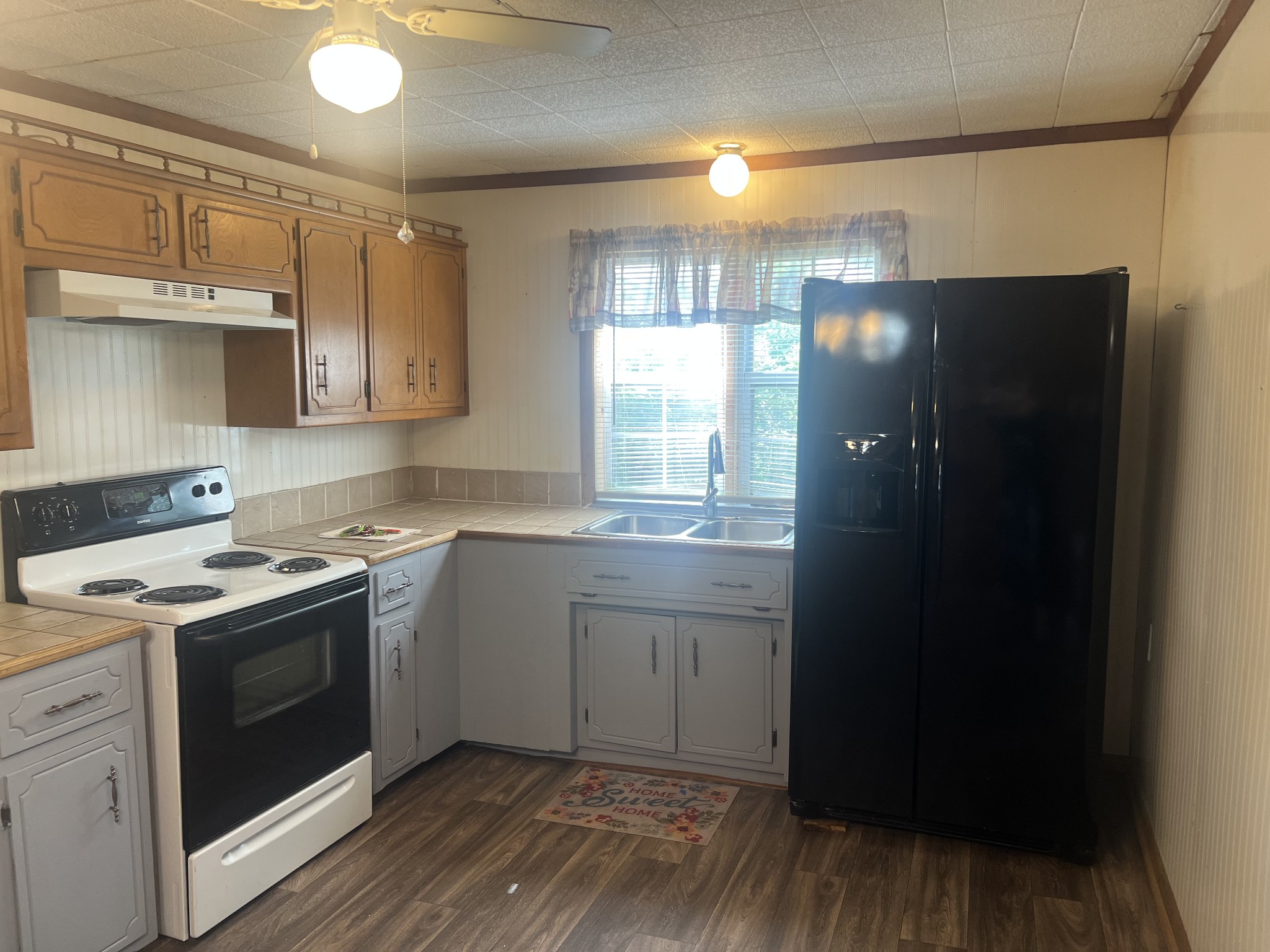 207 Powell Street Decherd, TN 37324 - Photo 17 of 18 a kitchen with a sink stove and refrigerator