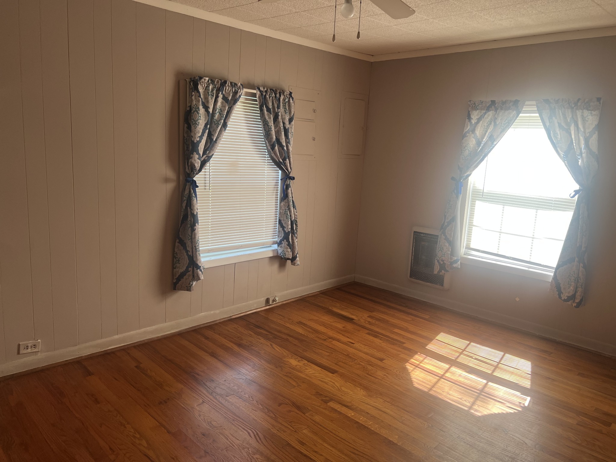 207 Powell Street Decherd, TN 37324 - Photo 9 of 18 an empty room with wooden floor and windows