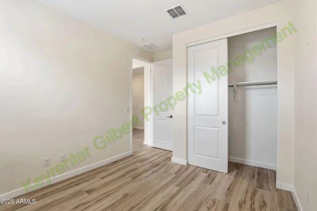 a large kitchen with kitchen island white cabinets and stainless steel appliances
