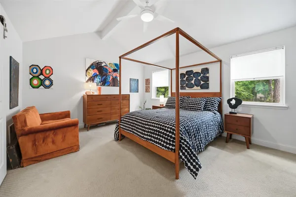 a bedroom with a bed and a window