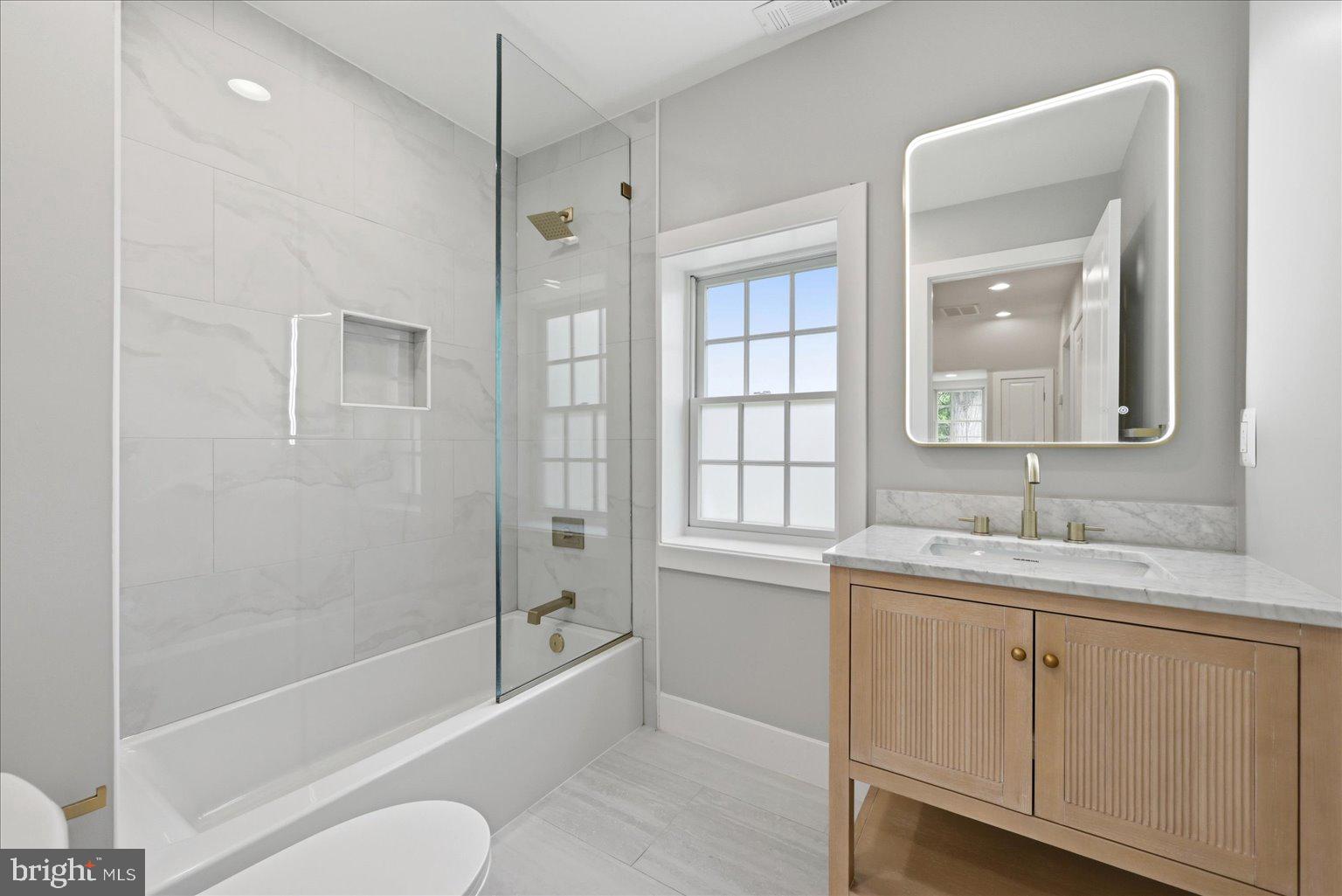 3517 Rodman Street Northwest Washington, DC 20008 - Photo 34 of 57 a bathroom with a granite countertop sink toilet and shower