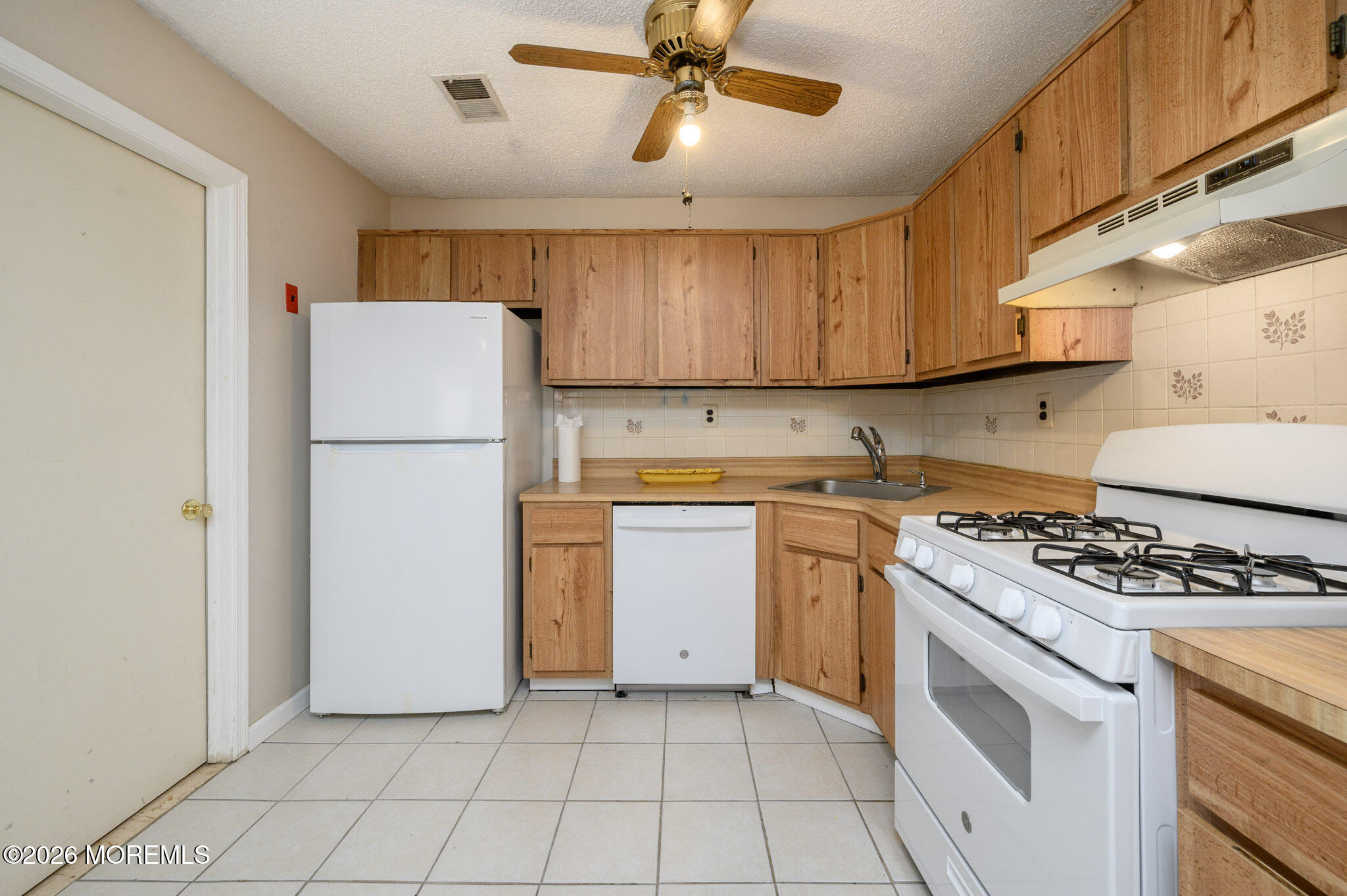 48 Frontier Way Tinton Falls, NJ 07753 - Photo 14 of 25 a kitchen with a stove a refrigerator and a sink