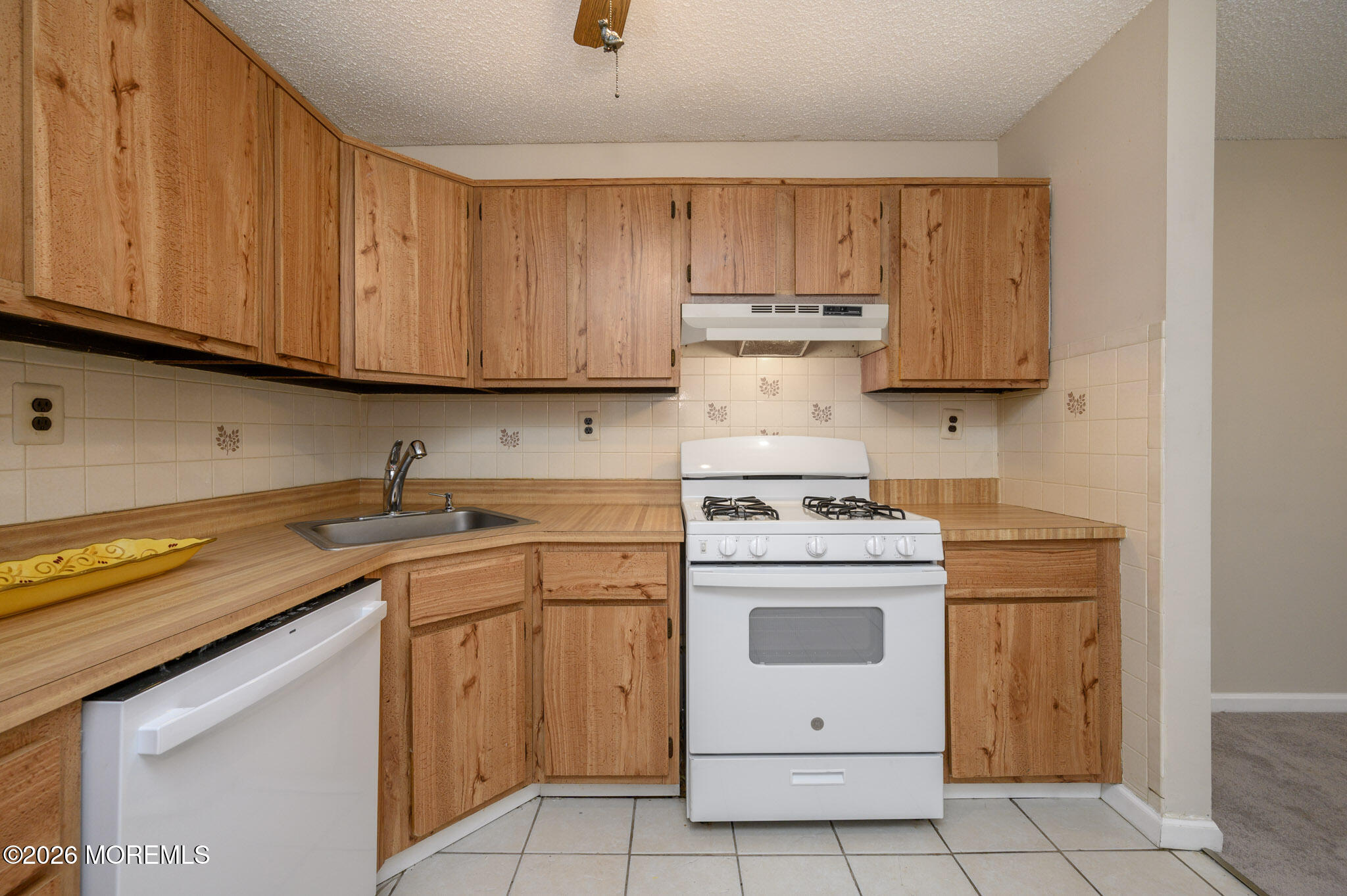 48 Frontier Way Tinton Falls, NJ 07753 - Photo 15 of 25 a kitchen with a stove sink and cabinets