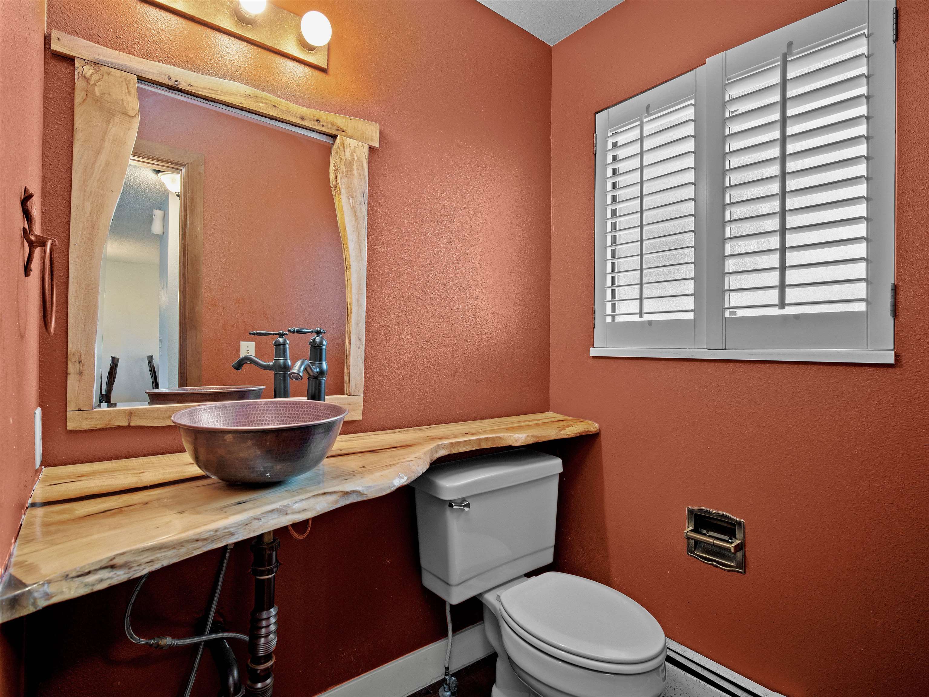 517 Rado Drive, Unit D Grand Junction, CO 81507 - Photo 7 of 24 a bathroom with a granite countertop toilet a sink a mirror and a window
