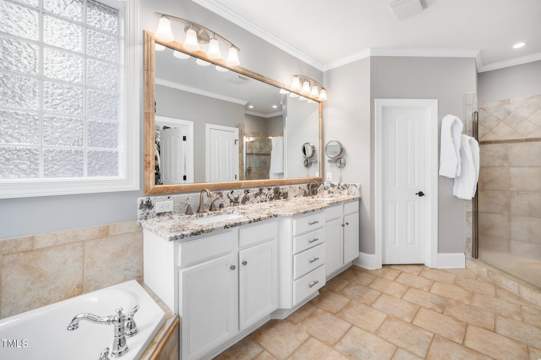 7001 Millstone Ridge Court Raleigh, NC 27614 - Photo 12 of 54 a bathroom with a granite countertop sink and a mirror