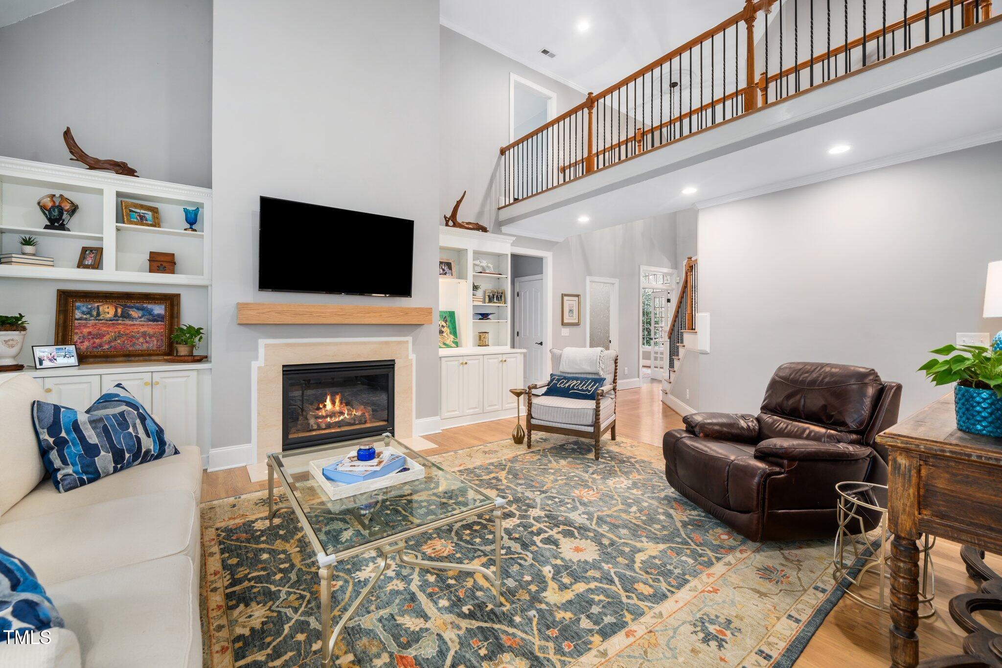 7001 Millstone Ridge Court Raleigh, NC 27614 - Photo 16 of 54 a living room with furniture a flat screen tv and a fireplace