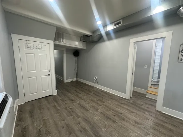 an empty room with wooden floor