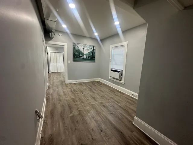 wooden floor in an empty room with a mirror