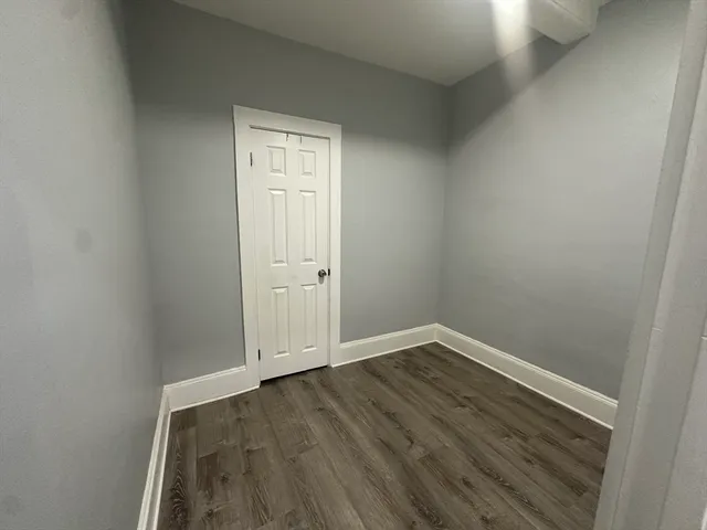 an empty room with wooden floor