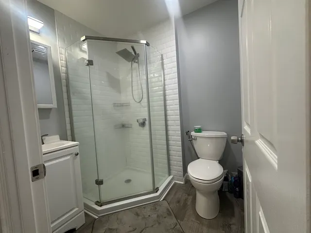 a bathroom with a toilet and a shower