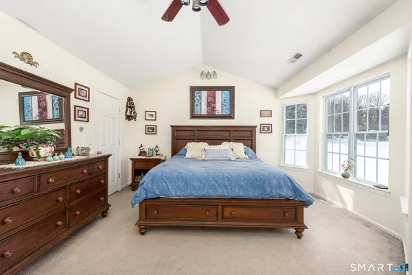 a bedroom with a bed and window