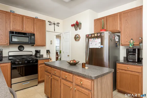 a kitchen with stainless steel appliances a stove microwave and refrigerator