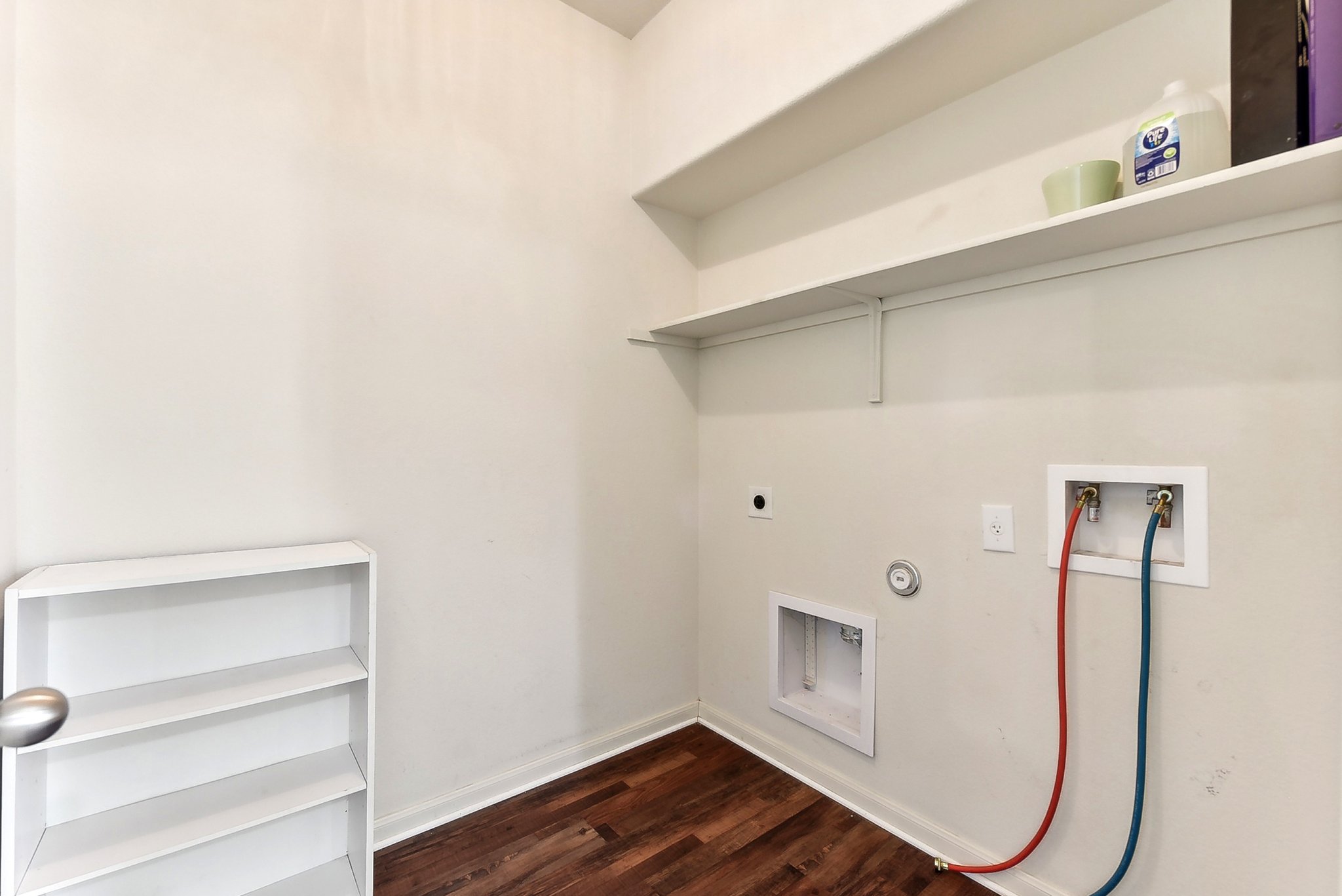 310 Potters Peak Way Georgetown, TX 78626 - Photo 10 of 21 Laundry area featuring wood-finish flooring, white walls, and built-in shelving