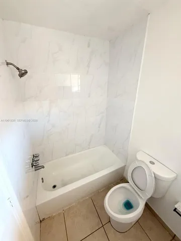 a kitchen with a refrigerator a stove top oven a sink and a window