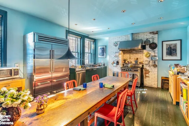 a dining room with furniture a chandelier and wooden floor
