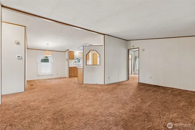 a view of a livingroom with a refrigerator cabinets and a wooden floor