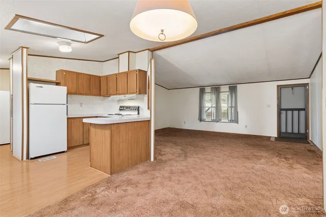 a view of kitchen with refrigerator and window