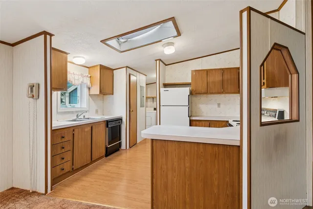 a kitchen with stainless steel appliances a refrigerator and a stove