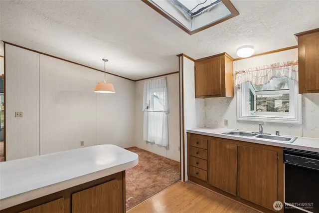 a room with a sink cabinets and a window
