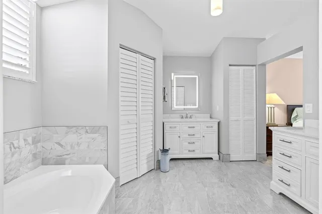 a kitchen with a sink cabinets stainless steel appliances and a window