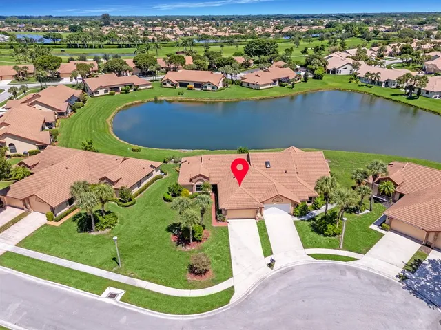 an aerial view of a swimming pool a yard and ocean view