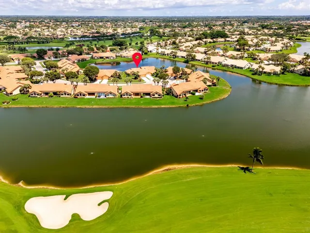 an aerial view of a residential houses with outdoor space and ocean view