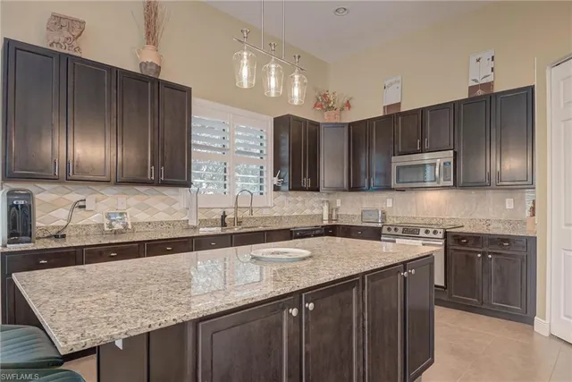 a kitchen with sink stove and cabinets