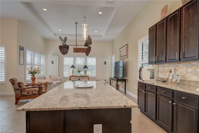 a kitchen with stainless steel appliances granite countertop a sink stove refrigerator and cabinets
