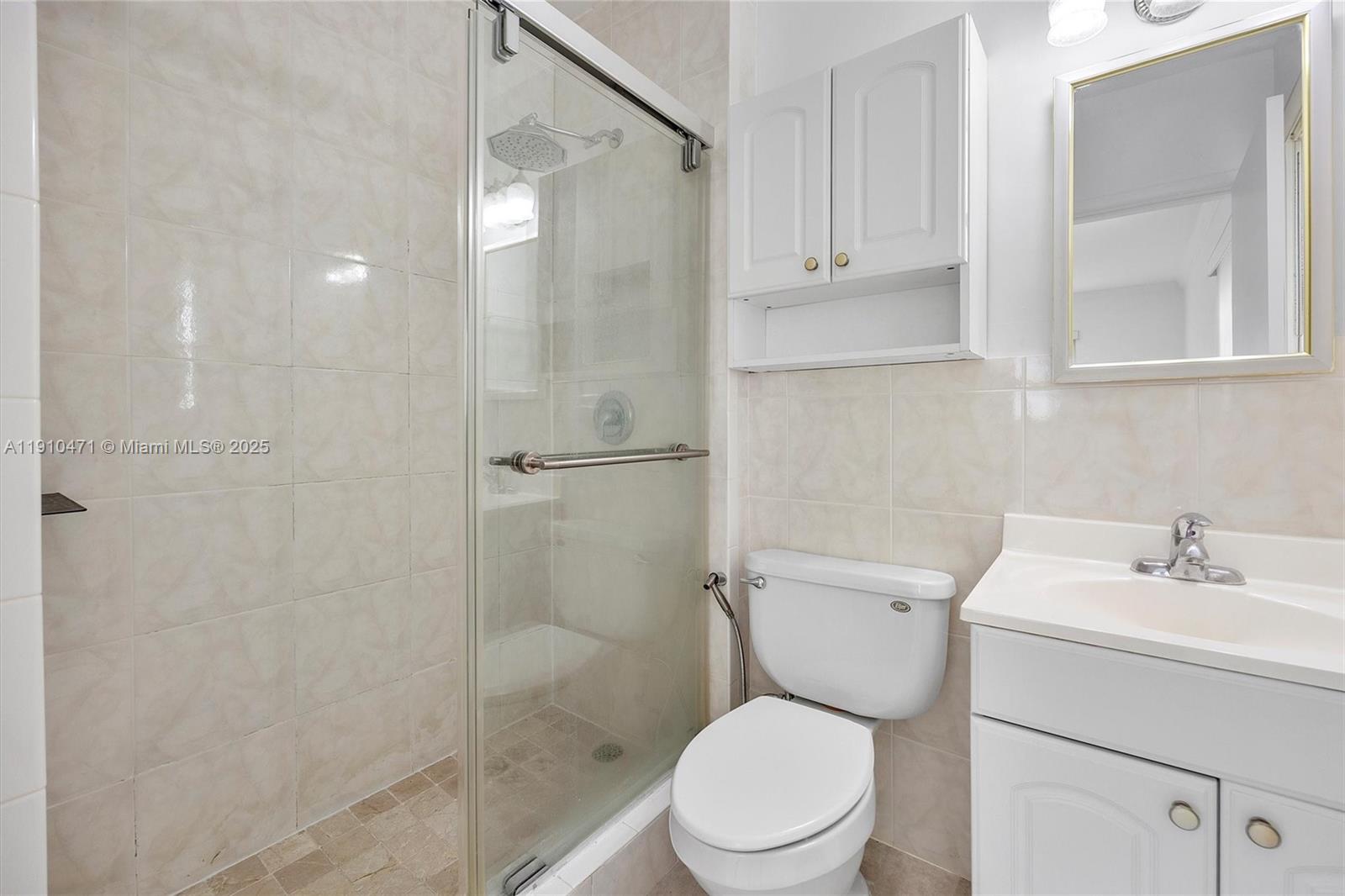 11111 Southwest 78th Court Pinecrest, FL 33156 - Photo 19 of 36 a white toilet sitting next to a bathroom sink