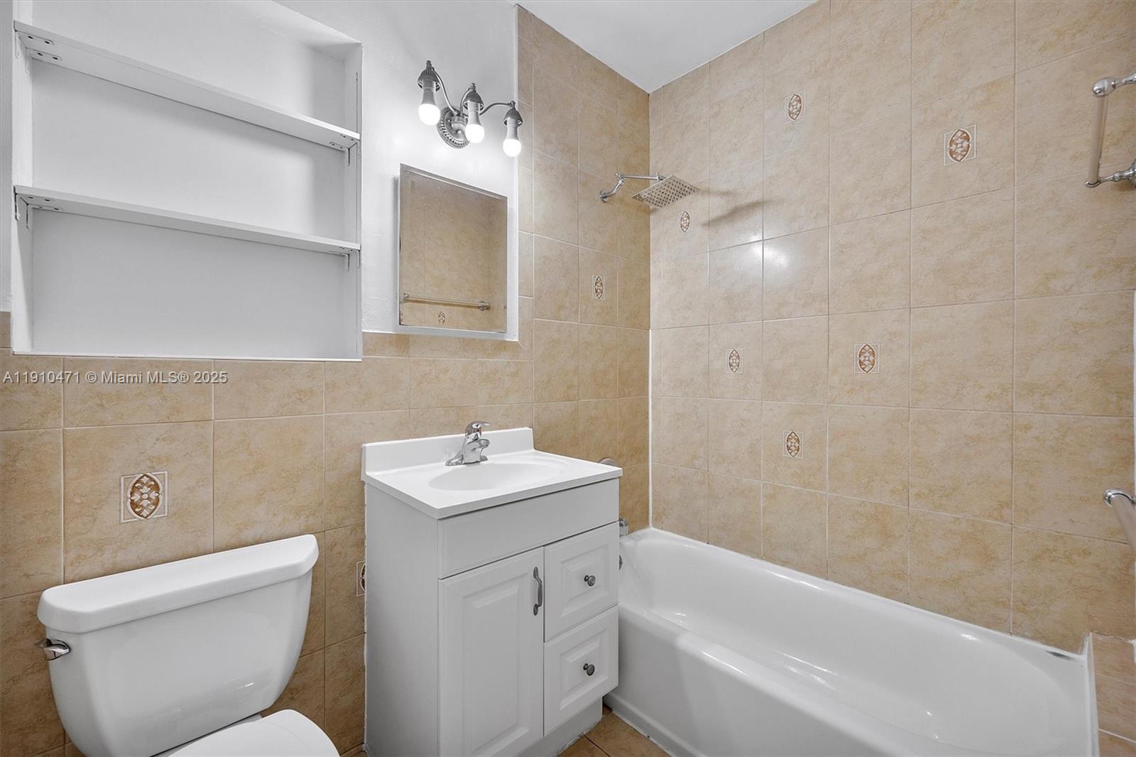 11111 Southwest 78th Court Pinecrest, FL 33156 - Photo 23 of 36 a bathroom with a toilet sink and bathtub