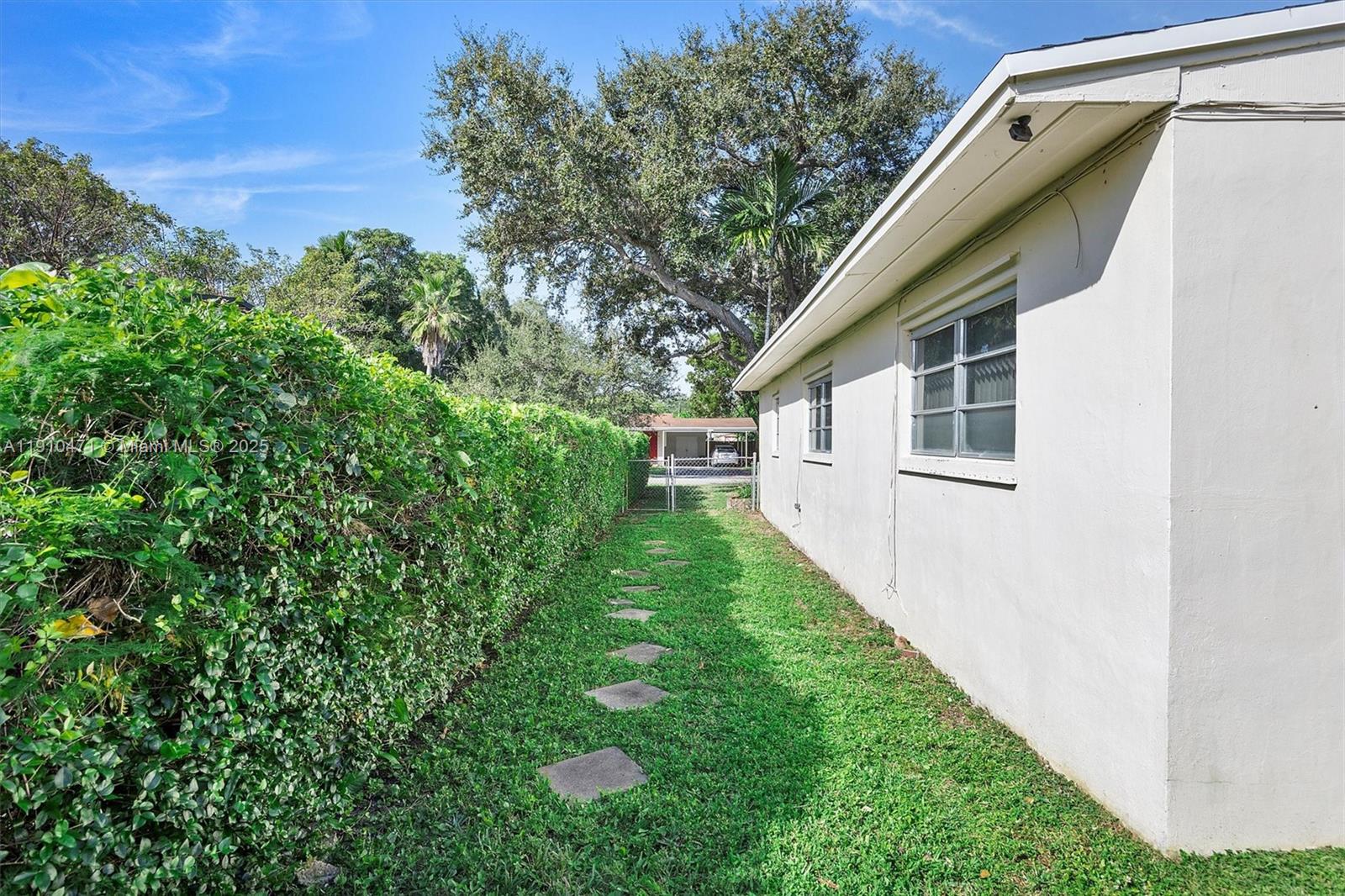 11111 Southwest 78th Court Pinecrest, FL 33156 - Photo 28 of 36 a view of a backyard with plants and a garden