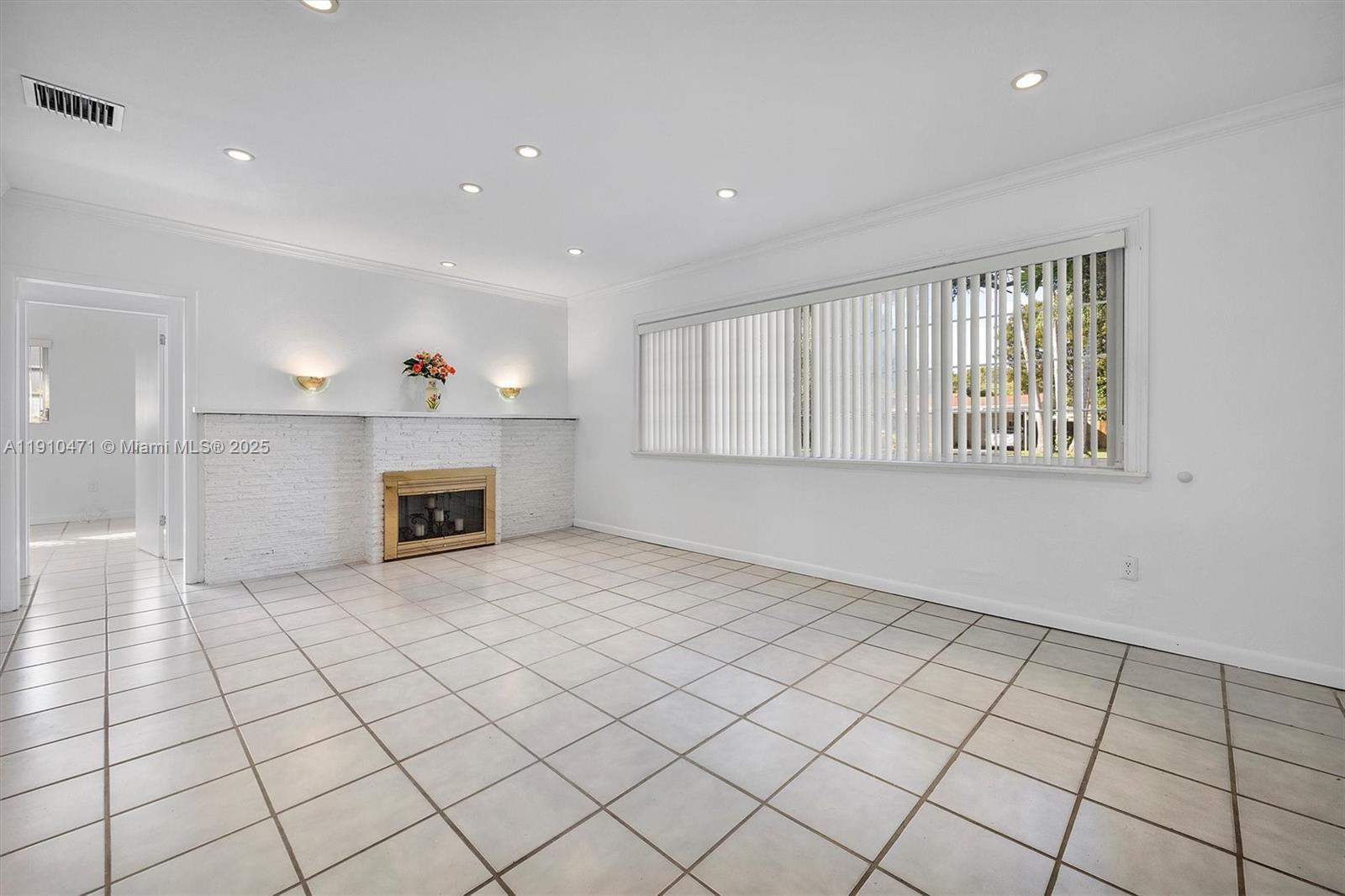 11111 Southwest 78th Court Pinecrest, FL 33156 - Photo 3 of 36 a view of an empty room with a fireplace