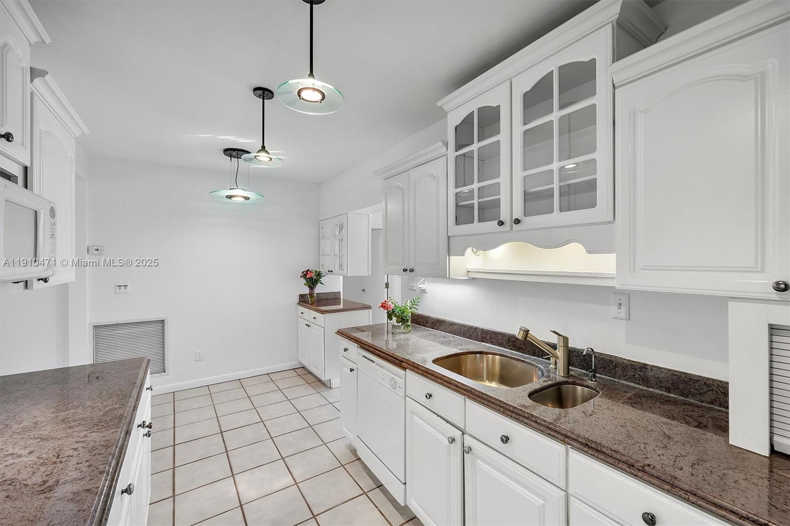 11111 Southwest 78th Court Pinecrest, FL 33156 - Photo 8 of 36 a kitchen with a sink and cabinets